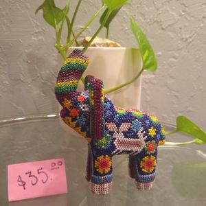 This is a wooden elephant with beads